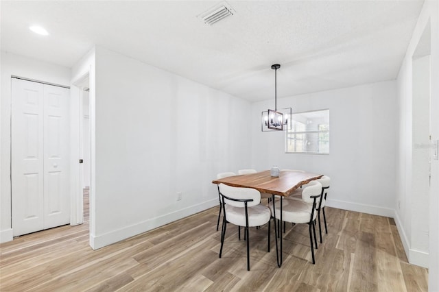 622 Cedar Grove Dr, Brandon, FL 33511 - dining area featuring light wood-type flooring, a chandelier, and baseboards