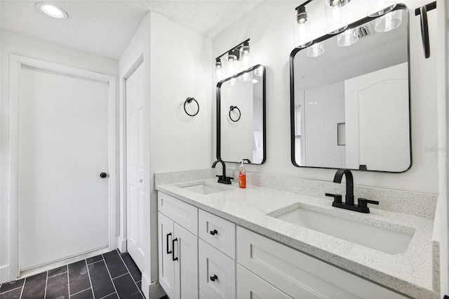 622 Cedar Grove Dr, Brandon, FL 33511 - bathroom with double vanity, a textured ceiling, and recessed lighting