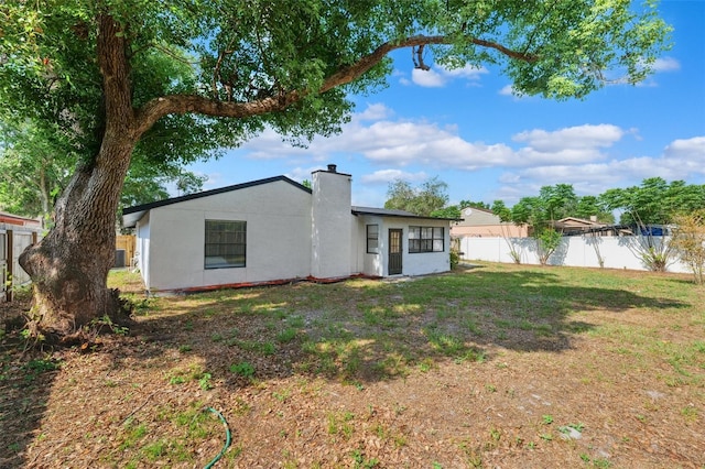622 Cedar Grove Dr, Brandon, FL 33511 - rear view of property featuring a chimney and stucco siding