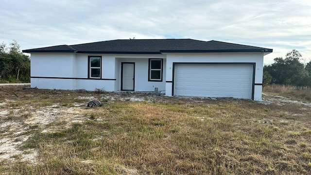 19233 Wilton Ave, Port Charlotte, FL 33954 - view of front of house with a garage, stucco siding, and a shingled roof