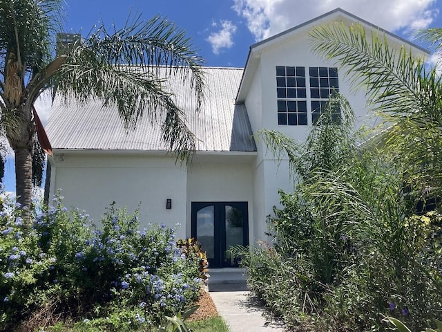 14510 Mj Rd, Myakka City, FL 34251 - view of front of house featuring stucco siding, french doors, and metal roof