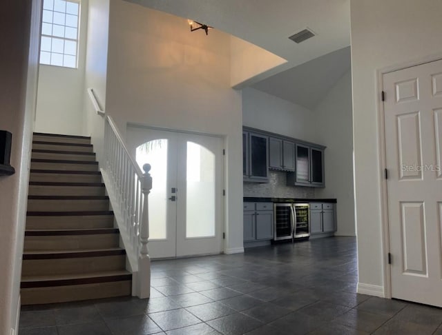 14510 Mj Rd, Myakka City, FL 34251 - entrance foyer with wine cooler, french doors, plenty of natural light, stairs, and a high ceiling