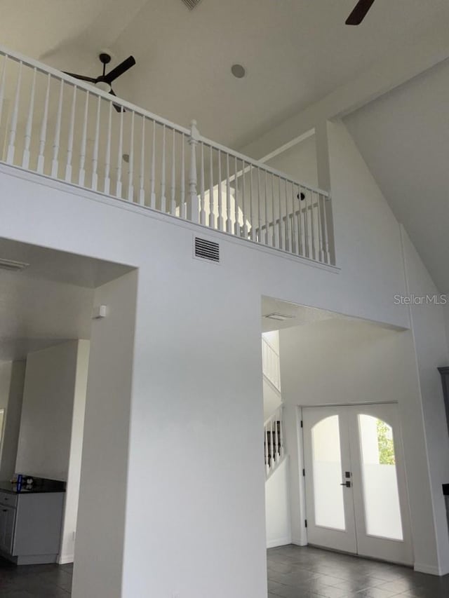 14510 Mj Rd, Myakka City, FL 34251 - staircase with a towering ceiling, a ceiling fan, french doors, and baseboards