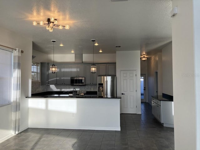 14510 Mj Rd, Myakka City, FL 34251 - kitchen featuring stainless steel appliances, dark countertops, dark tile patterned floors, and a textured ceiling
