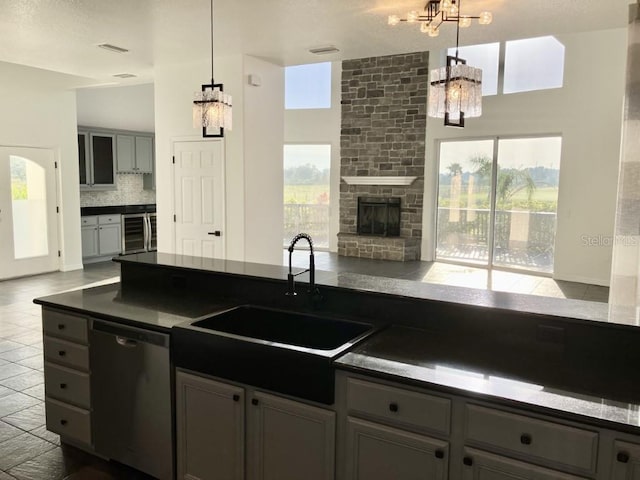 14510 Mj Rd, Myakka City, FL 34251 - kitchen with a chandelier, stainless steel dishwasher, a sink, wine cooler, and dark countertops