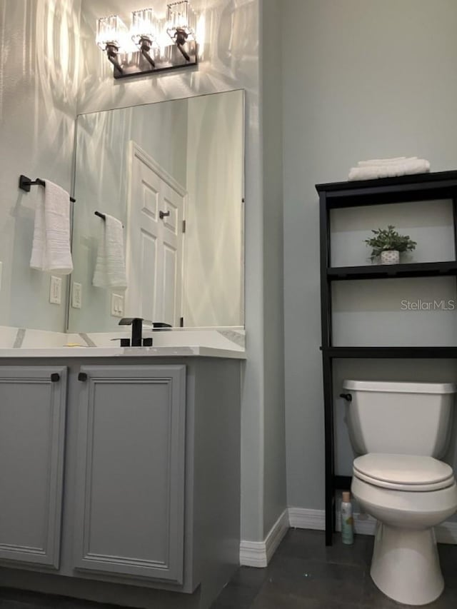 14510 Mj Rd, Myakka City, FL 34251 - bathroom with vanity, toilet, baseboards, and a chandelier