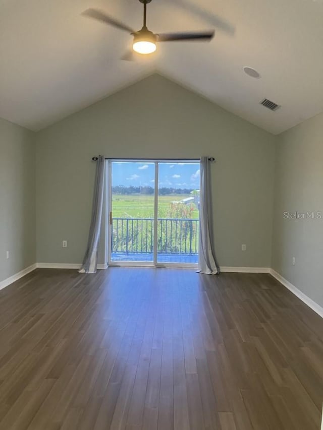 14510 Mj Rd, Myakka City, FL 34251 - empty room featuring a ceiling fan, dark wood-style flooring, vaulted ceiling, and baseboards