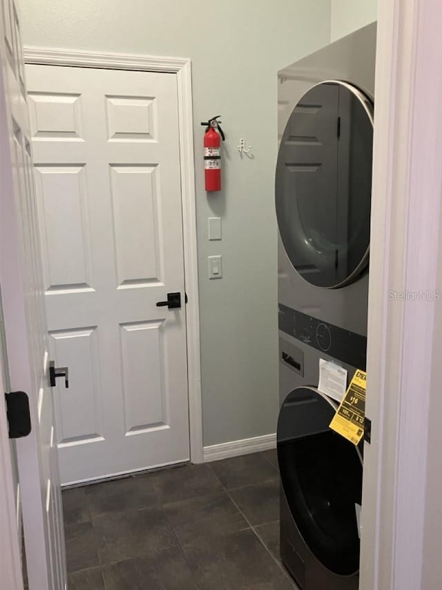 14510 Mj Rd, Myakka City, FL 34251 - laundry area with stacked washing machine and dryer and baseboards