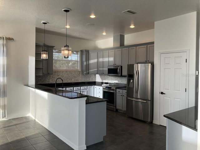 14510 Mj Rd, Myakka City, FL 34251 - kitchen with appliances with stainless steel finishes, dark countertops, a peninsula, tasteful backsplash, and recessed lighting