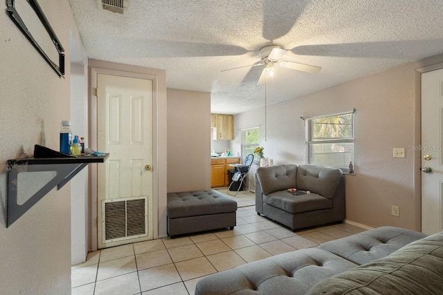 1224 S Delaware Ave, Deland, FL 32720 - living area with ceiling fan, light tile patterned floors, and a textured ceiling