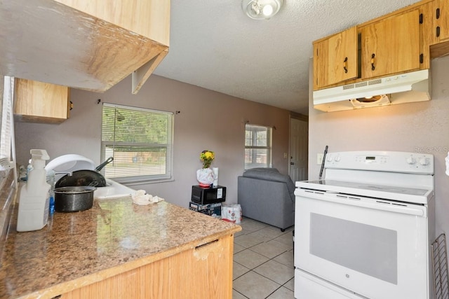 1224 S Delaware Ave, Deland, FL 32720 - kitchen featuring white range with electric stovetop, under cabinet range hood, light tile patterned flooring, light countertops, and a textured ceiling