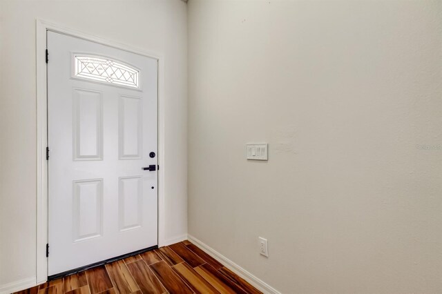 5435 Birchwood Rd, Spring Hill, FL 34608 - foyer featuring baseboards and dark wood-type flooring