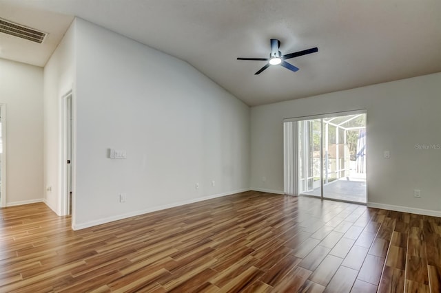 5435 Birchwood Rd, Spring Hill, FL 34608 - spare room with wood finished floors, ceiling fan, lofted ceiling, and baseboards