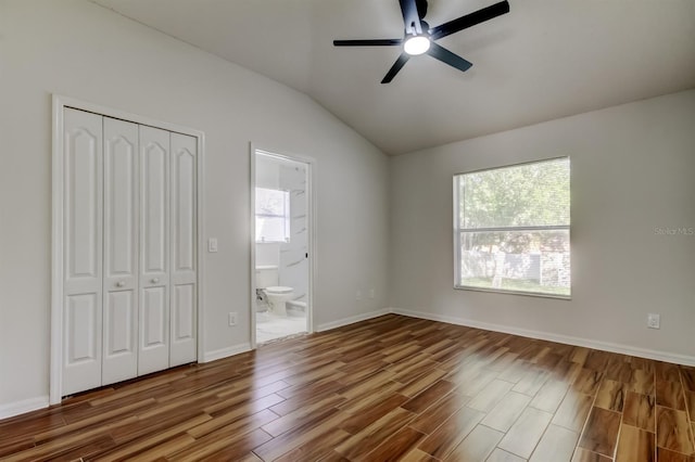 5435 Birchwood Rd, Spring Hill, FL 34608 - unfurnished bedroom featuring wood finished floors, vaulted ceiling, a closet, connected bathroom, and ceiling fan