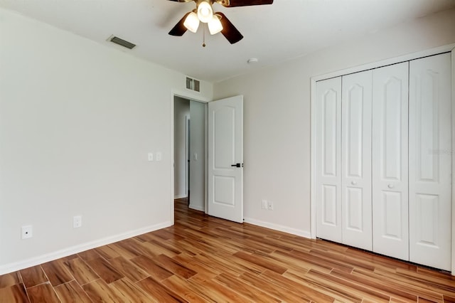 5435 Birchwood Rd, Spring Hill, FL 34608 - unfurnished bedroom featuring light wood-type flooring, a closet, baseboards, and a ceiling fan
