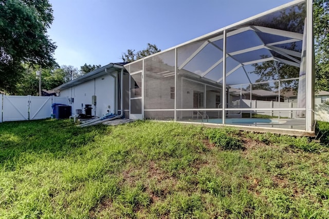 5435 Birchwood Rd, Spring Hill, FL 34608 - rear view of house featuring a gate, a lanai, and central AC