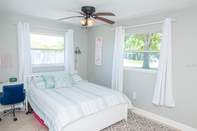 489 Fox Run Trl, Apollo Beach, FL 33572 - bedroom with multiple windows, ceiling fan, baseboards, and light tile patterned floors