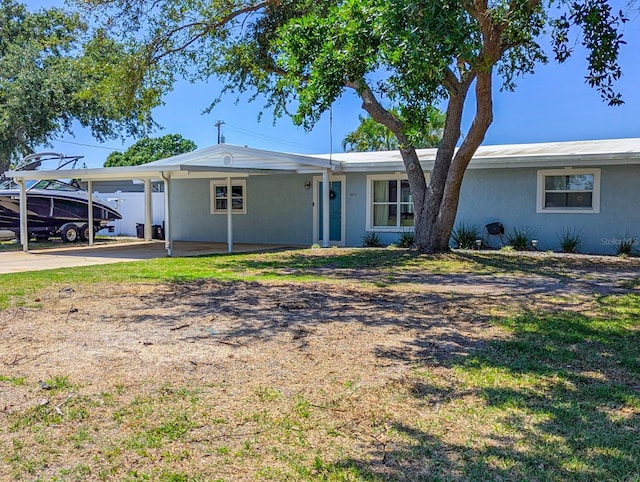 489 Fox Run Trl, Apollo Beach, FL 33572 - ranch-style house featuring a carport, driveway, and stucco siding