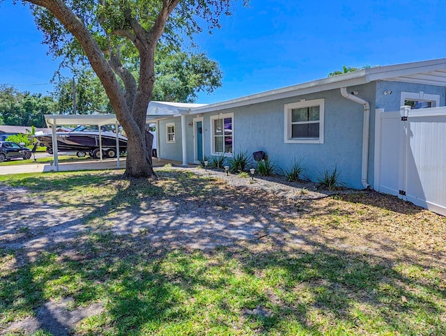 489 Fox Run Trl, Apollo Beach, FL 33572 - ranch-style home featuring stucco siding and a carport