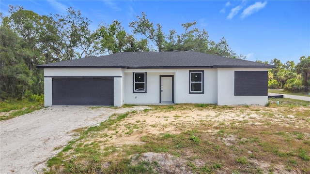 16134 Libourn Ave, Port Charlotte, FL 33954 - ranch-style home with a garage, driveway, stucco siding, and roof with shingles