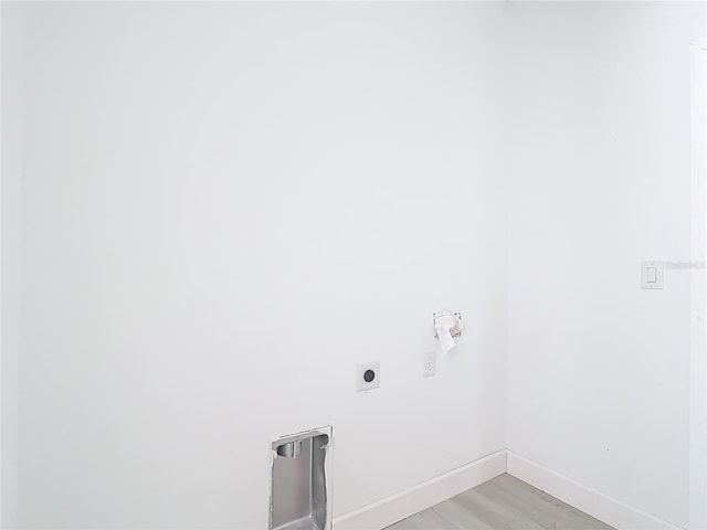 16134 Libourn Ave, Port Charlotte, FL 33954 - laundry area featuring electric dryer hookup, baseboards, and light wood finished floors