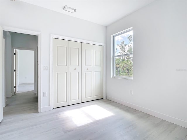 16134 Libourn Ave, Port Charlotte, FL 33954 - unfurnished bedroom featuring light wood finished floors, baseboards, and a closet