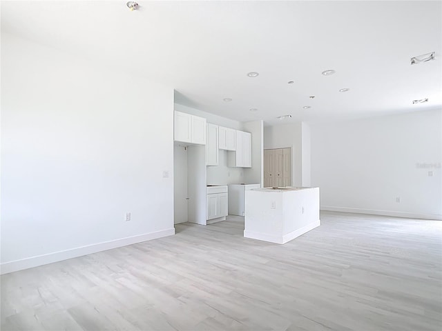 16134 Libourn Ave, Port Charlotte, FL 33954 - unfurnished living room featuring recessed lighting, baseboards, and light wood finished floors