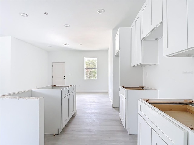 16134 Libourn Ave, Port Charlotte, FL 33954 - kitchen featuring a kitchen island, light wood-style flooring, white cabinetry, recessed lighting, and baseboards