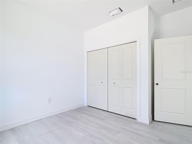 16134 Libourn Ave, Port Charlotte, FL 33954 - unfurnished bedroom featuring light wood-style floors, baseboards, and a closet