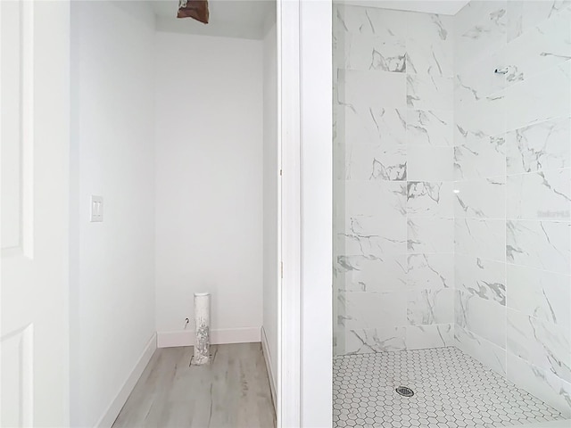 16134 Libourn Ave, Port Charlotte, FL 33954 - bathroom with a tile shower, wood finished floors, and baseboards