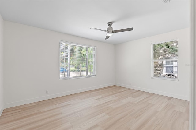 2449 16th St N, Saint Petersburg, FL 33704 - spare room with light wood-style floors, baseboards, and a ceiling fan