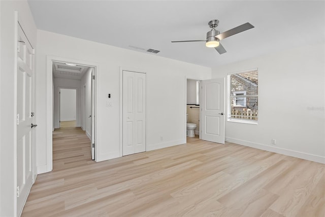 2449 16th St N, Saint Petersburg, FL 33704 - unfurnished bedroom with light wood-style flooring, baseboards, ensuite bath, and ceiling fan