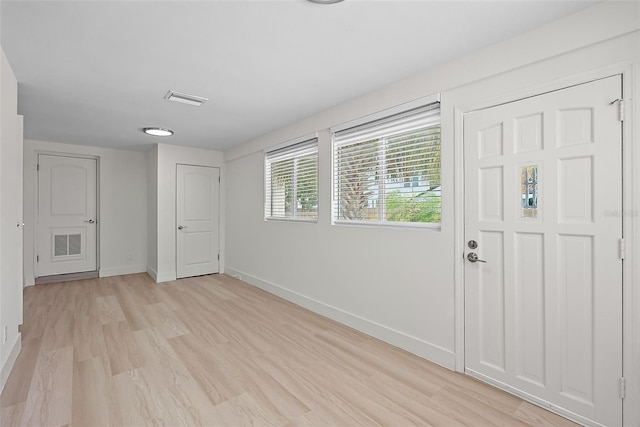 2449 16th St N, Saint Petersburg, FL 33704 - entryway featuring baseboards and light wood finished floors
