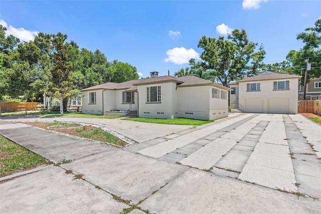 2449 16th St N, Saint Petersburg, FL 33704 - view of front facade with an attached garage, concrete driveway, and stucco siding