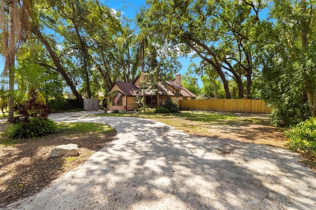 717 E 137th Ave, Tampa, FL 33613 - view of front of home featuring a chimney and curved driveway