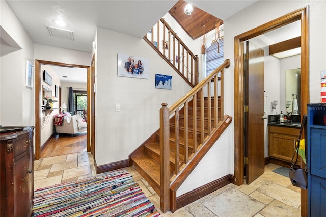 717 E 137th Ave, Tampa, FL 33613 - stairs featuring stone tile floors and baseboards