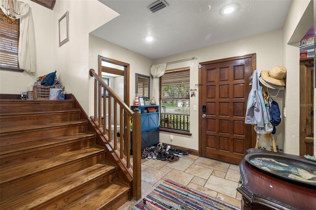 717 E 137th Ave, Tampa, FL 33613 - foyer featuring stone tile floors, stairs, baseboards, and recessed lighting
