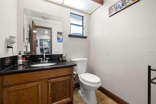 717 E 137th Ave, Tampa, FL 33613 - bathroom with toilet, vanity, and baseboards