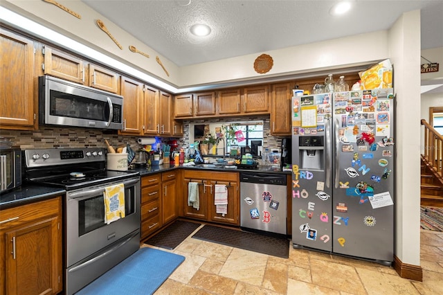 717 E 137th Ave, Tampa, FL 33613 - kitchen with appliances with stainless steel finishes, a sink, dark countertops, tasteful backsplash, and brown cabinetry