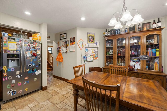 717 E 137th Ave, Tampa, FL 33613 - dining area featuring stone tile floors, stairway, a chandelier, recessed lighting, and baseboards