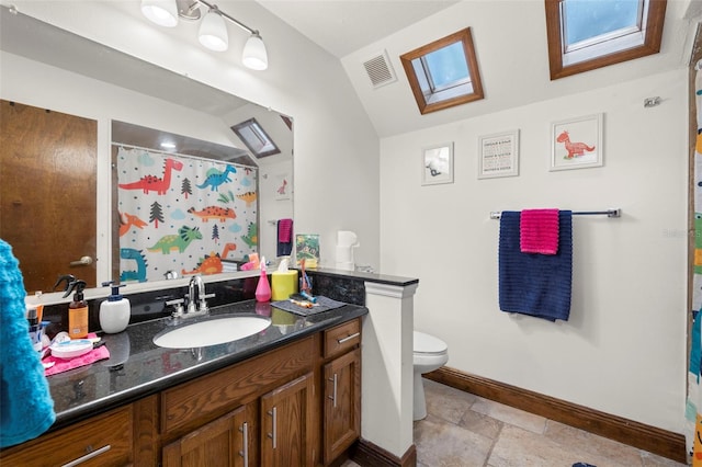 717 E 137th Ave, Tampa, FL 33613 - full bath featuring a skylight, vanity, toilet, baseboards, and stone tile floors
