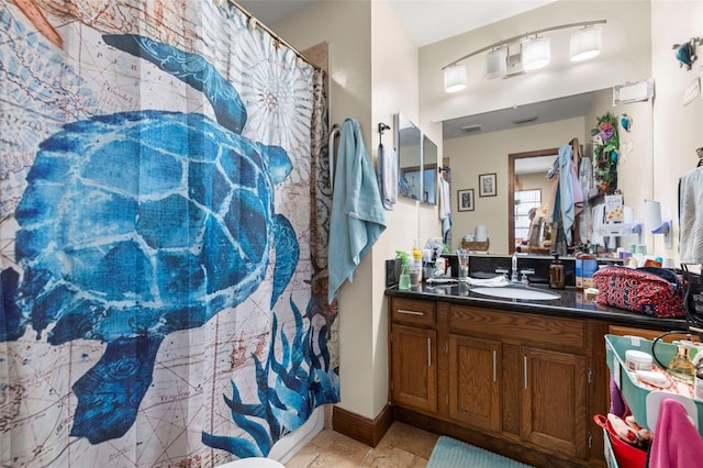 717 E 137th Ave, Tampa, FL 33613 - bathroom featuring vanity, curtained shower, and baseboards