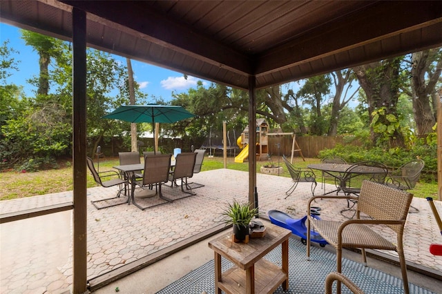 717 E 137th Ave, Tampa, FL 33613 - fenced backyard featuring outdoor dining area, a playground, and a patio