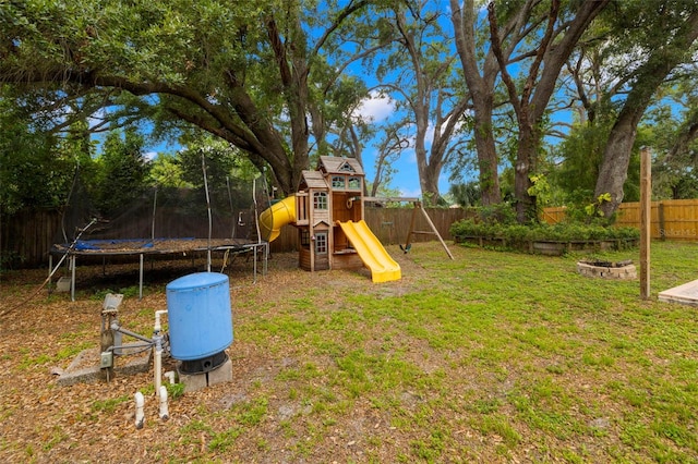 717 E 137th Ave, Tampa, FL 33613 - view of yard featuring a trampoline, a playground, and a fire pit