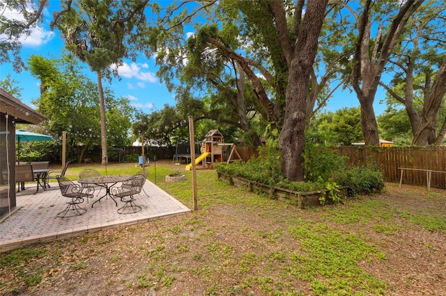 717 E 137th Ave, Tampa, FL 33613 - view of yard with a playground and a patio area