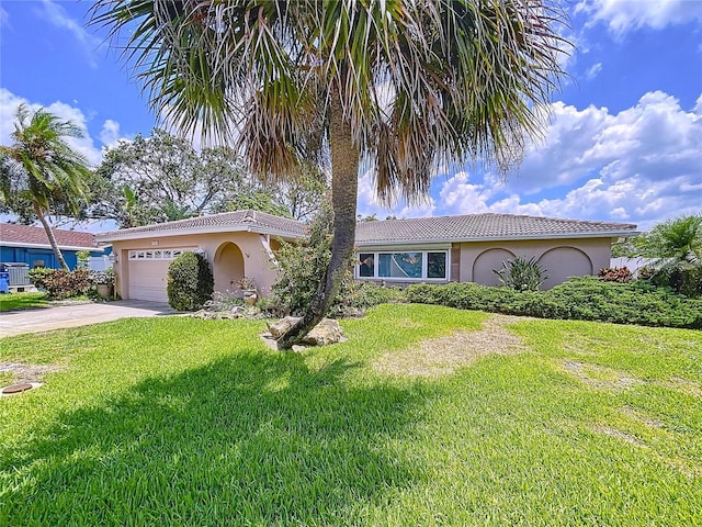 9631 Oak St NE, Saint Petersburg, FL 33702 - view of front of property featuring stucco siding, a garage, a front lawn, and concrete driveway