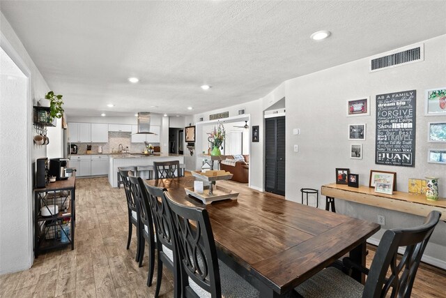 7304 Lakeside Blvd, Tampa, FL 33614 - dining room featuring light wood-style floors, recessed lighting, and a textured ceiling