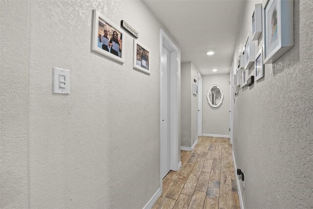 7304 Lakeside Blvd, Tampa, FL 33614 - hall featuring wood finished floors, baseboards, a textured wall, and recessed lighting