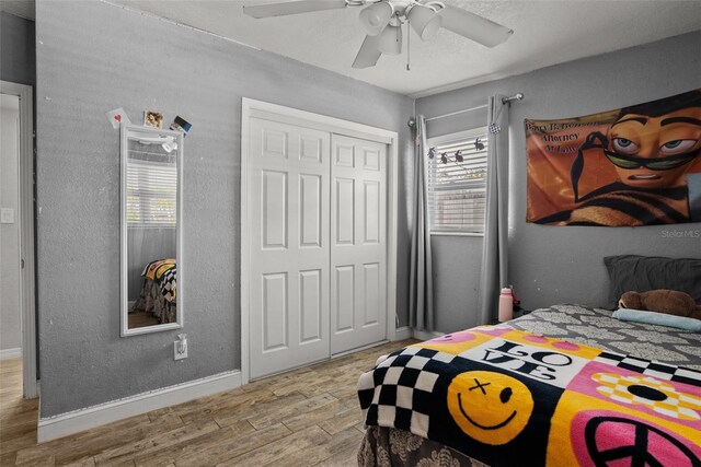 7304 Lakeside Blvd, Tampa, FL 33614 - bedroom with wood finished floors, multiple windows, baseboards, and a closet