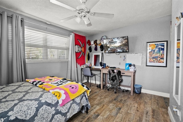 7304 Lakeside Blvd, Tampa, FL 33614 - bedroom featuring wood finished floors, a textured ceiling, baseboards, and ceiling fan